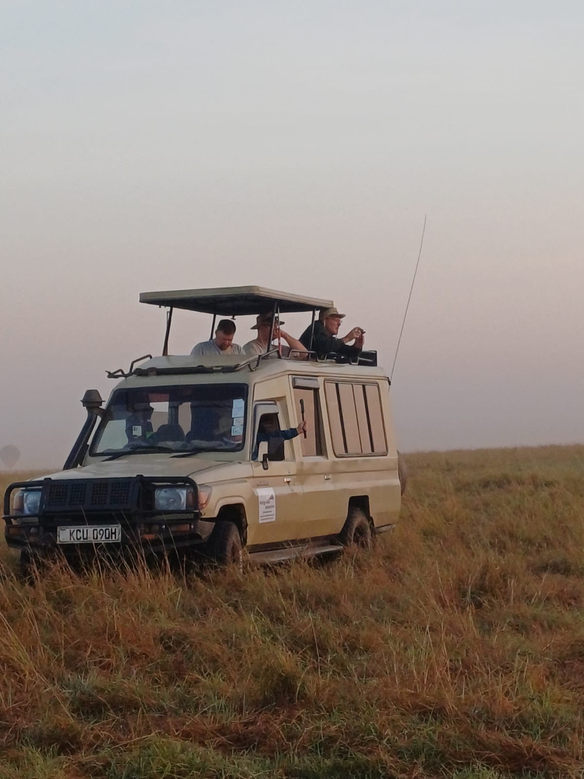 Guests on an early-morning game drive in a Mzingo safari vehicle
