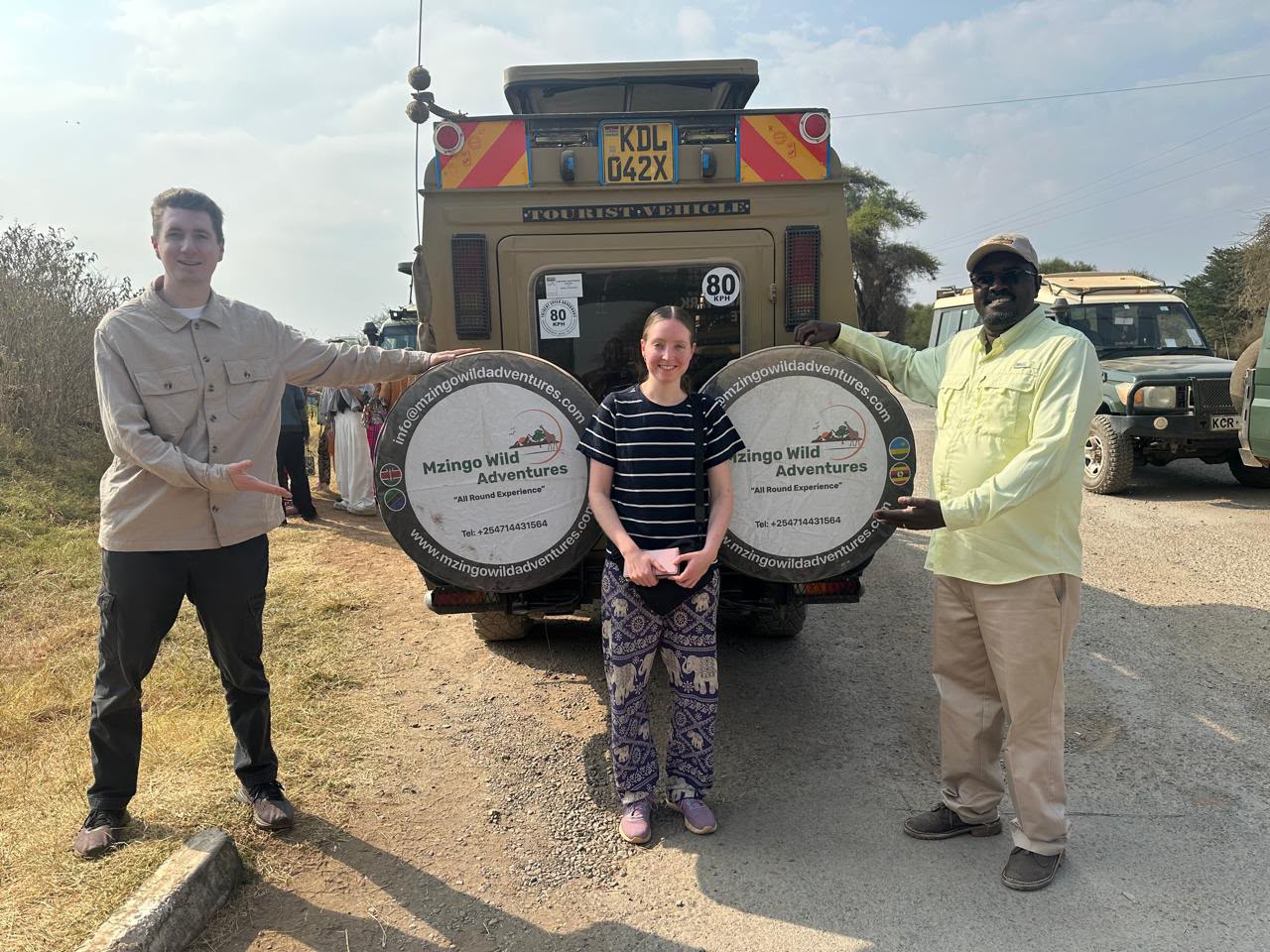Guests and their Mzingo guide with the branded safari vehicle